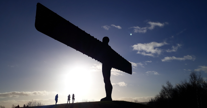 people standing below the Angel of the North, Gateshead.